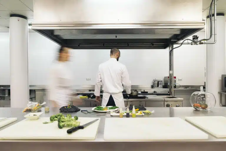 Two professionals chefs cooking together in a kitchen.