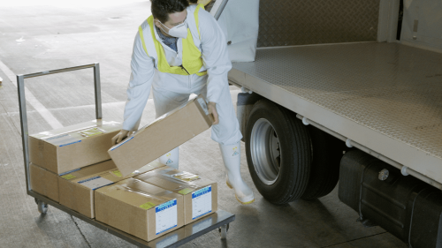 Someone loading a box into a truck